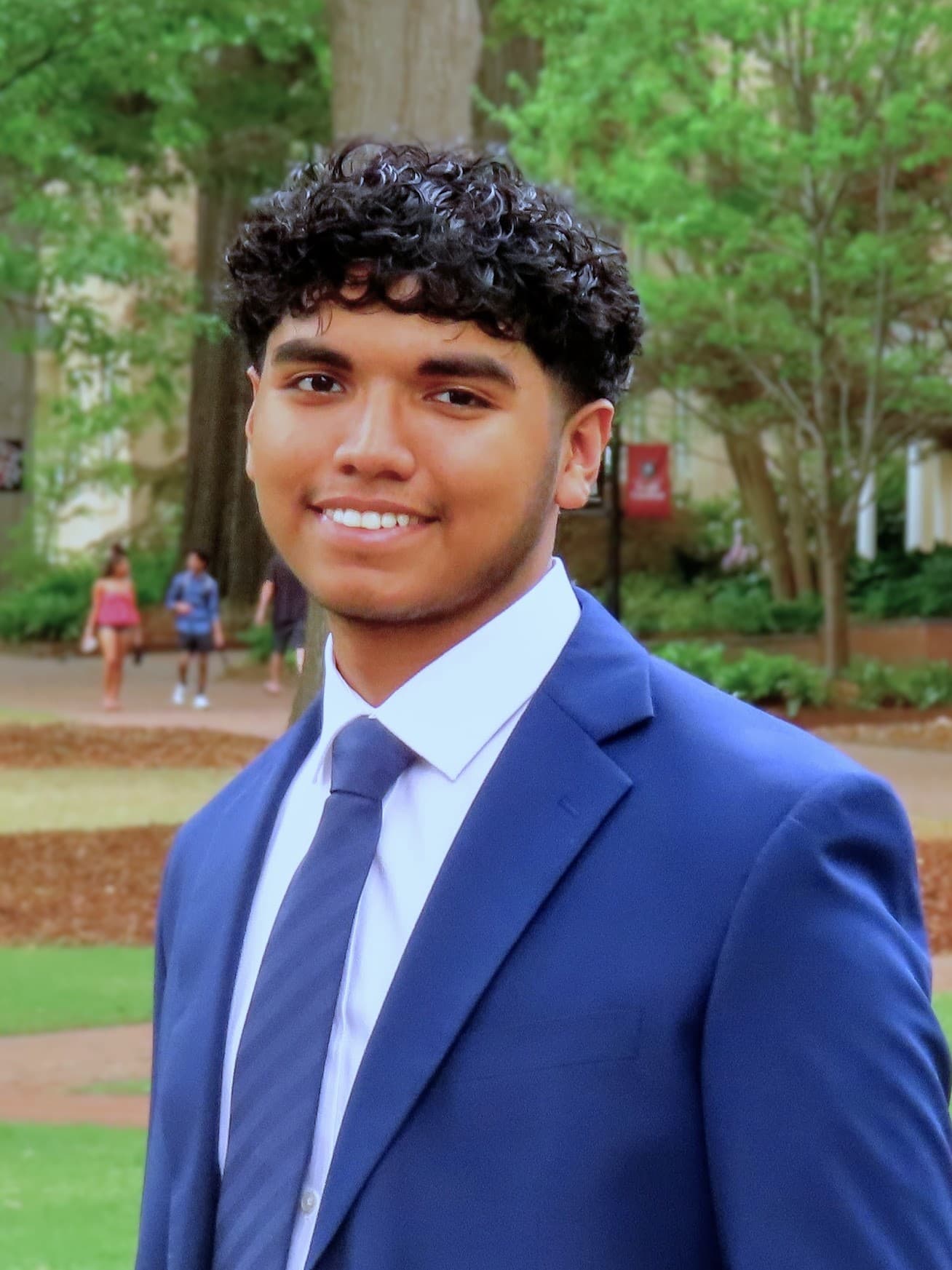 Maximus Fernandez wearing a blue suit outdoors